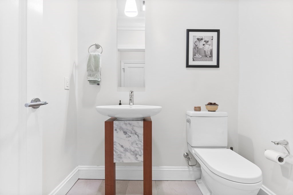 192 West Springfield Street, Unit 1 Boston, MA 02118 - Photo 13 of 26 a bathroom with a toilet sink and mirror