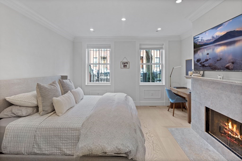 192 West Springfield Street, Unit 1 Boston, MA 02118 - Photo 14 of 26 a bedroom with a bed and a fireplace