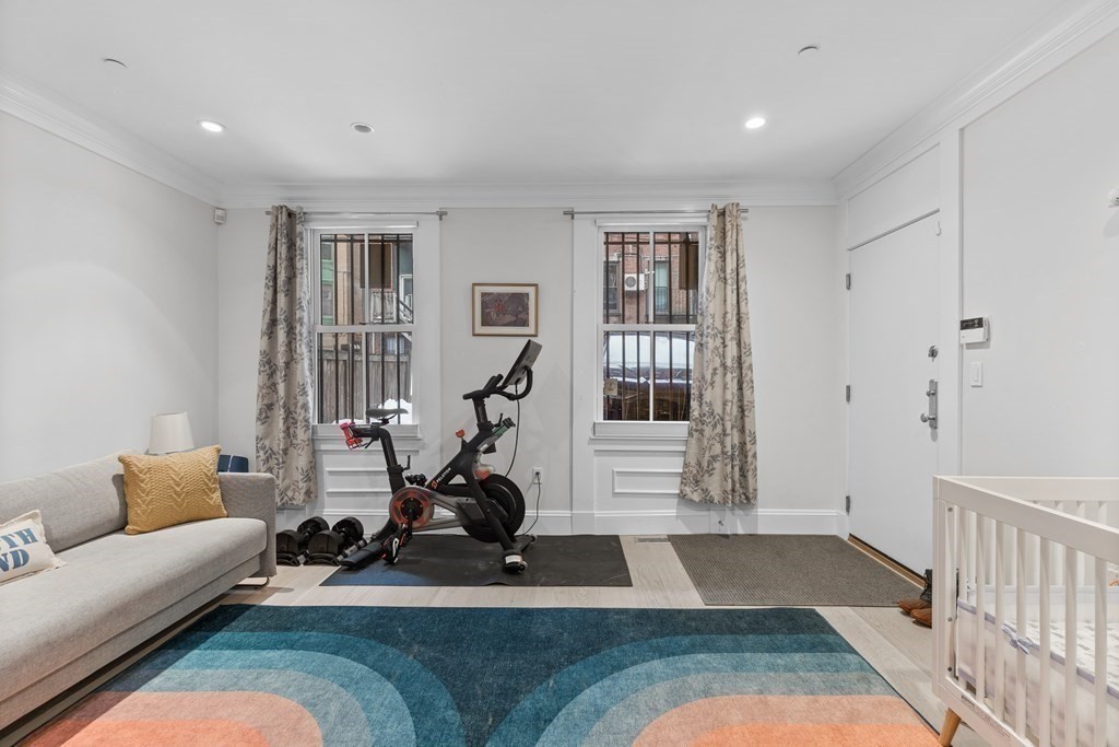 192 West Springfield Street, Unit 1 Boston, MA 02118 - Photo 19 of 26 a living room with furniture gym equipment and a large window