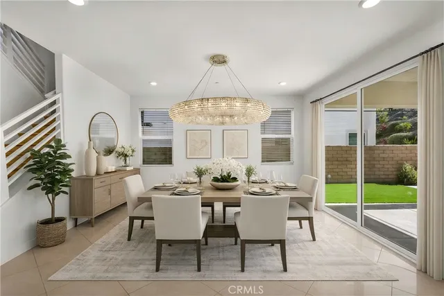 a dining room with furniture wooden floor and a chandelier