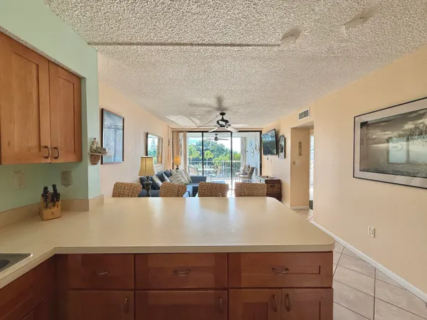 a view of a living room with furniture and floor to ceiling windows