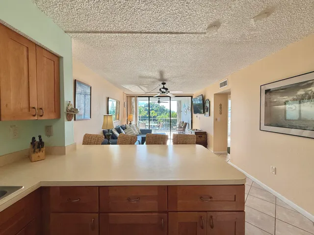 a view of a living room with furniture and floor to ceiling windows