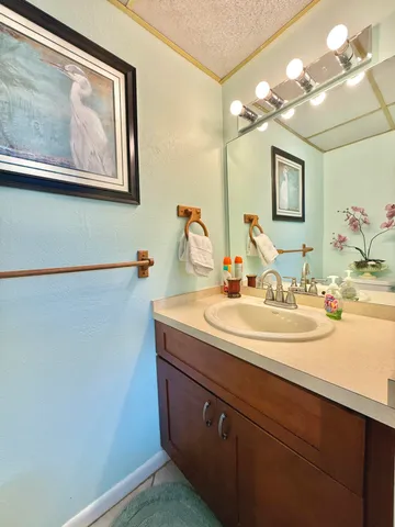 a kitchen with stainless steel appliances granite countertop a sink a stove a refrigerator with grey cabinets