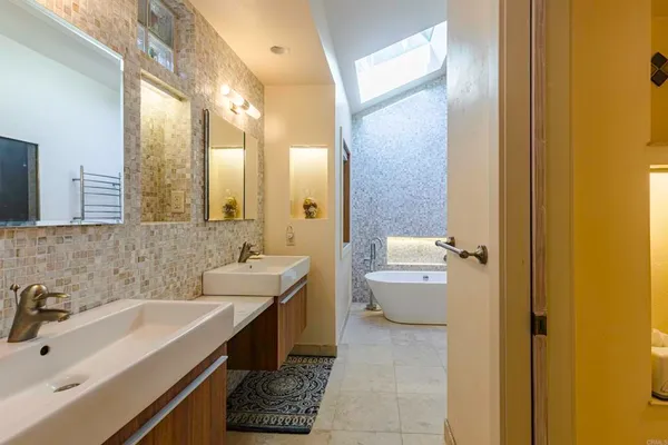 a bathroom with a sink and mirror with toilet