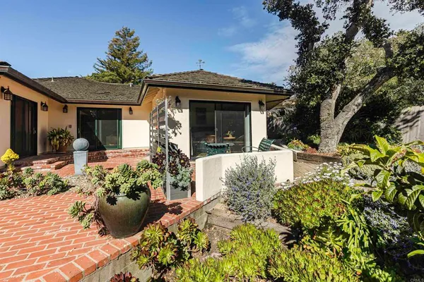 a bedroom with furniture and a large window