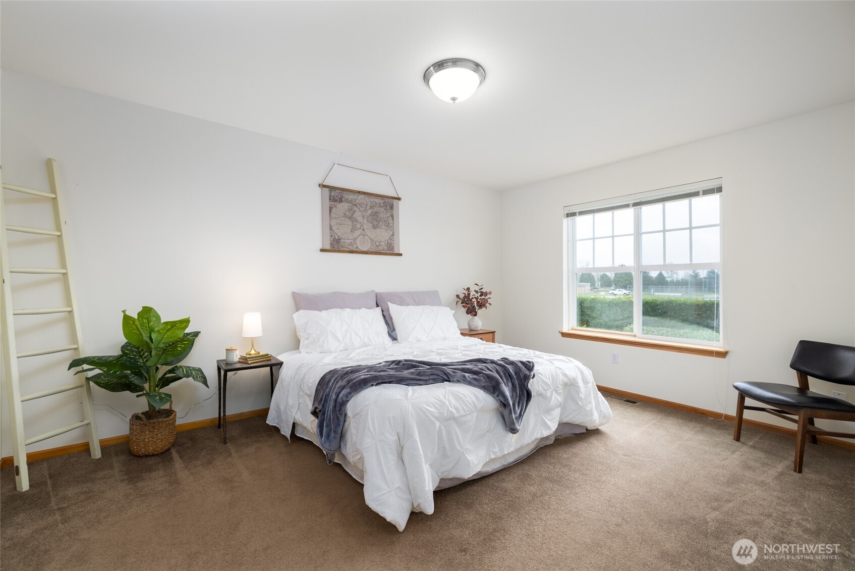 1182 Decatur Circle, Unit 7A Burlington, WA 98233 - Photo 19 of 36 a bed sitting in a bedroom next to a window