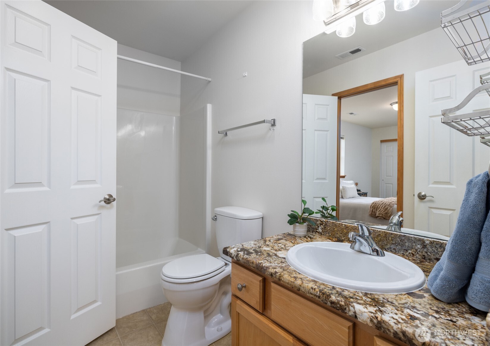 1182 Decatur Circle, Unit 7A Burlington, WA 98233 - Photo 27 of 36 a bathroom with a granite countertop sink a toilet a mirror and shower