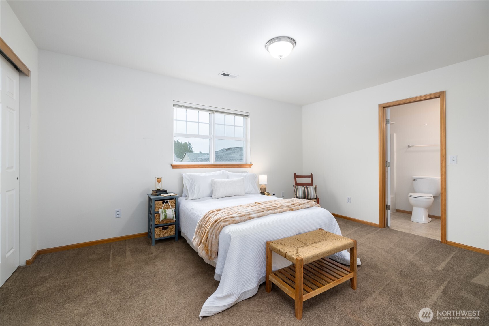 1182 Decatur Circle, Unit 7A Burlington, WA 98233 - Photo 28 of 36 a bed sitting in a bedroom next to a window