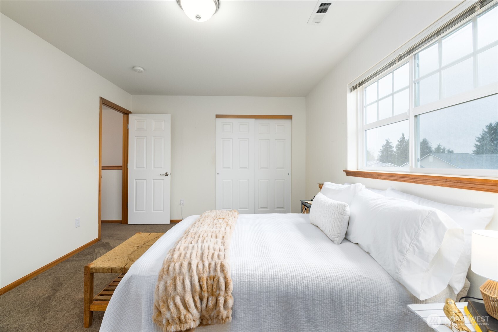 1182 Decatur Circle, Unit 7A Burlington, WA 98233 - Photo 29 of 36 a bedroom with a bed and a large window