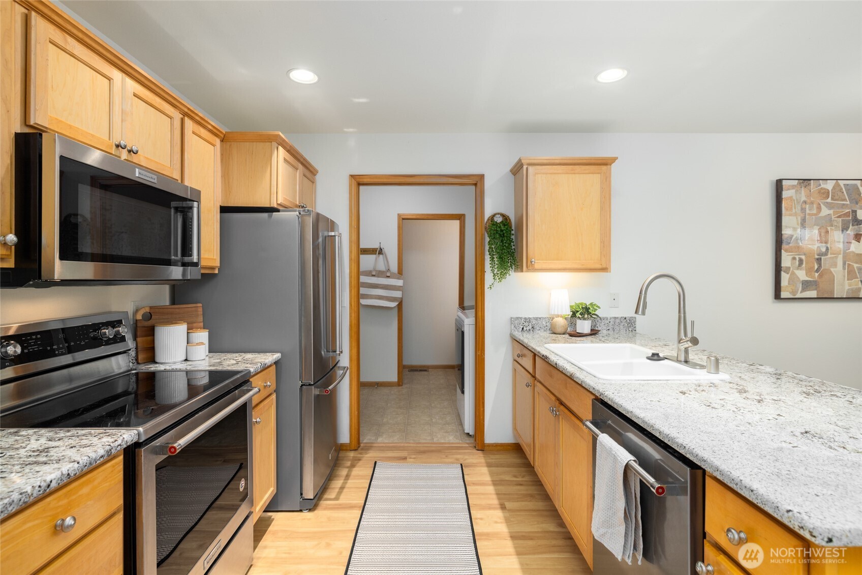 1182 Decatur Circle, Unit 7A Burlington, WA 98233 - Photo 6 of 36 a kitchen with stainless steel appliances granite countertop a sink stove refrigerator and cabinets