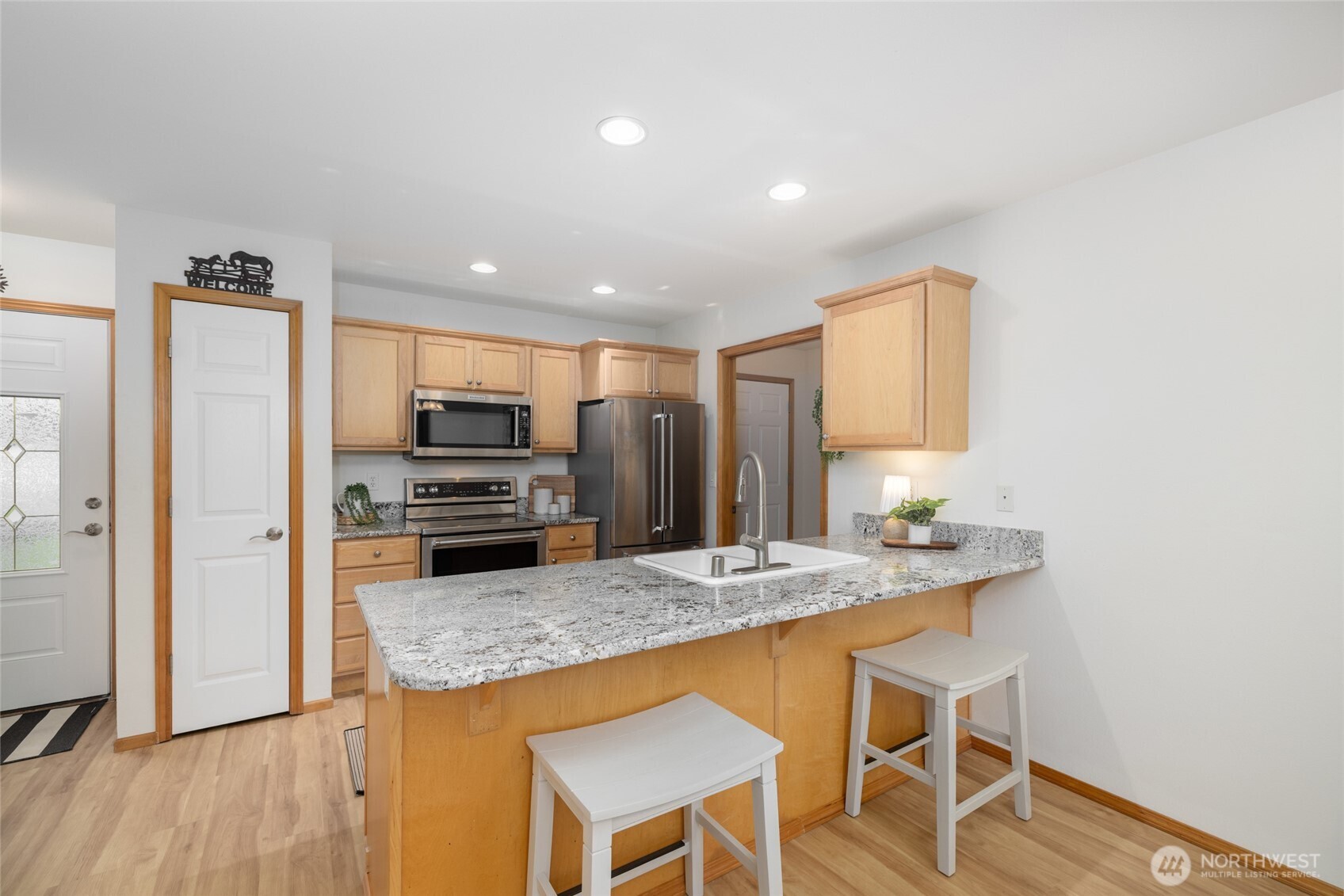 1182 Decatur Circle, Unit 7A Burlington, WA 98233 - Photo 10 of 36 a kitchen with kitchen island a counter top space cabinets and stainless steel appliances