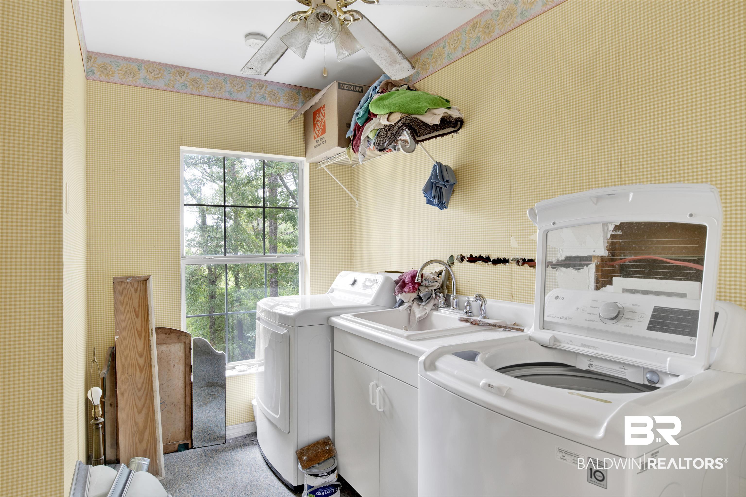 7641 Hitt Road Mobile, AL 36695 - Photo 22 of 29 Laundry area featuring ceiling fan, light carpet, and separate washer and dryer