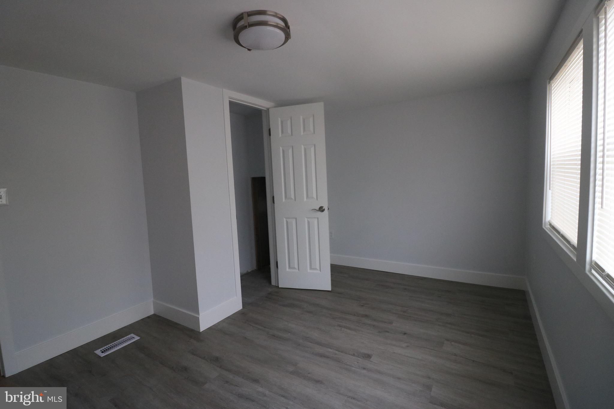 121 Bengies Road Middle River, MD 21220 - Photo 4 of 6 an empty room with wooden floor and windows