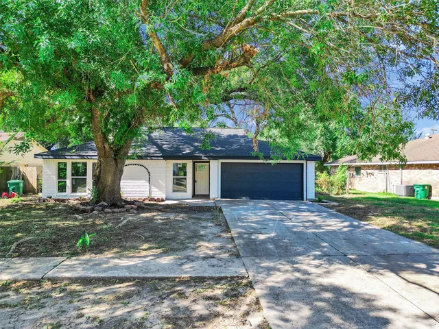 a front view of a house with a yard and a garage