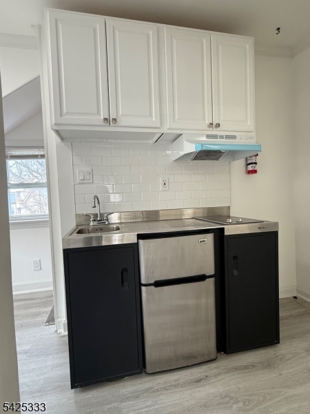 124 Stone Street, Unit 3 Newark, NJ 07104 - Photo 2 of 10 a kitchen with stainless steel appliances granite countertop a refrigerator and cabinets