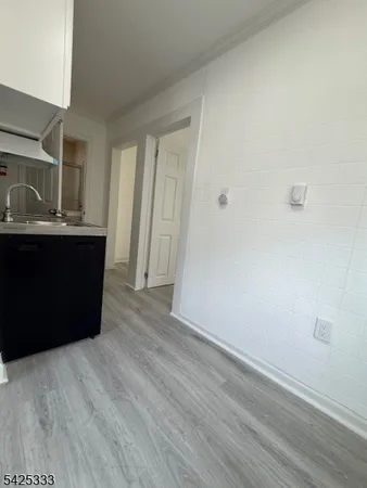 a room with wooden floor and window
