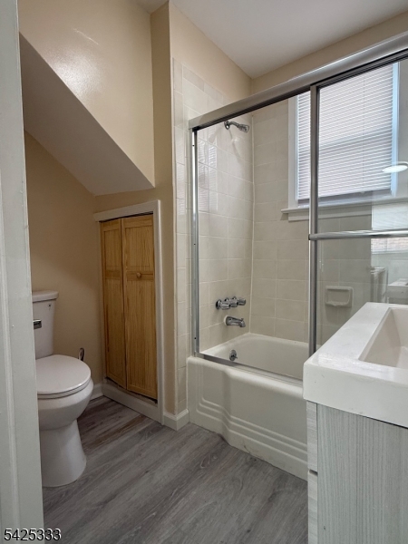 124 Stone Street, Unit 3 Newark, NJ 07104 - Photo 9 of 10 a bathroom with a sink a toilet and shower