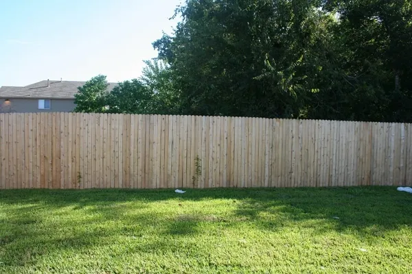 a view of backyard with wooden fences