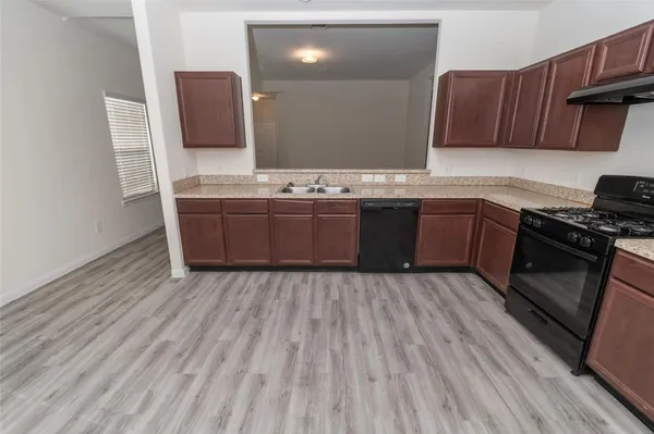 a kitchen with stainless steel appliances granite countertop a sink stove and microwave