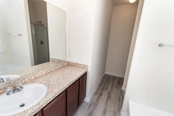 a bathroom with a granite countertop sink and a mirror