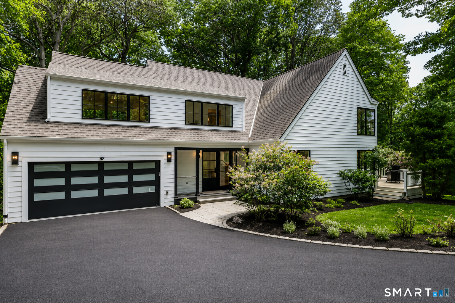 256 Wilton Road East Ridgefield, CT 06877 - Photo 2 of 40 a house view with a garden space