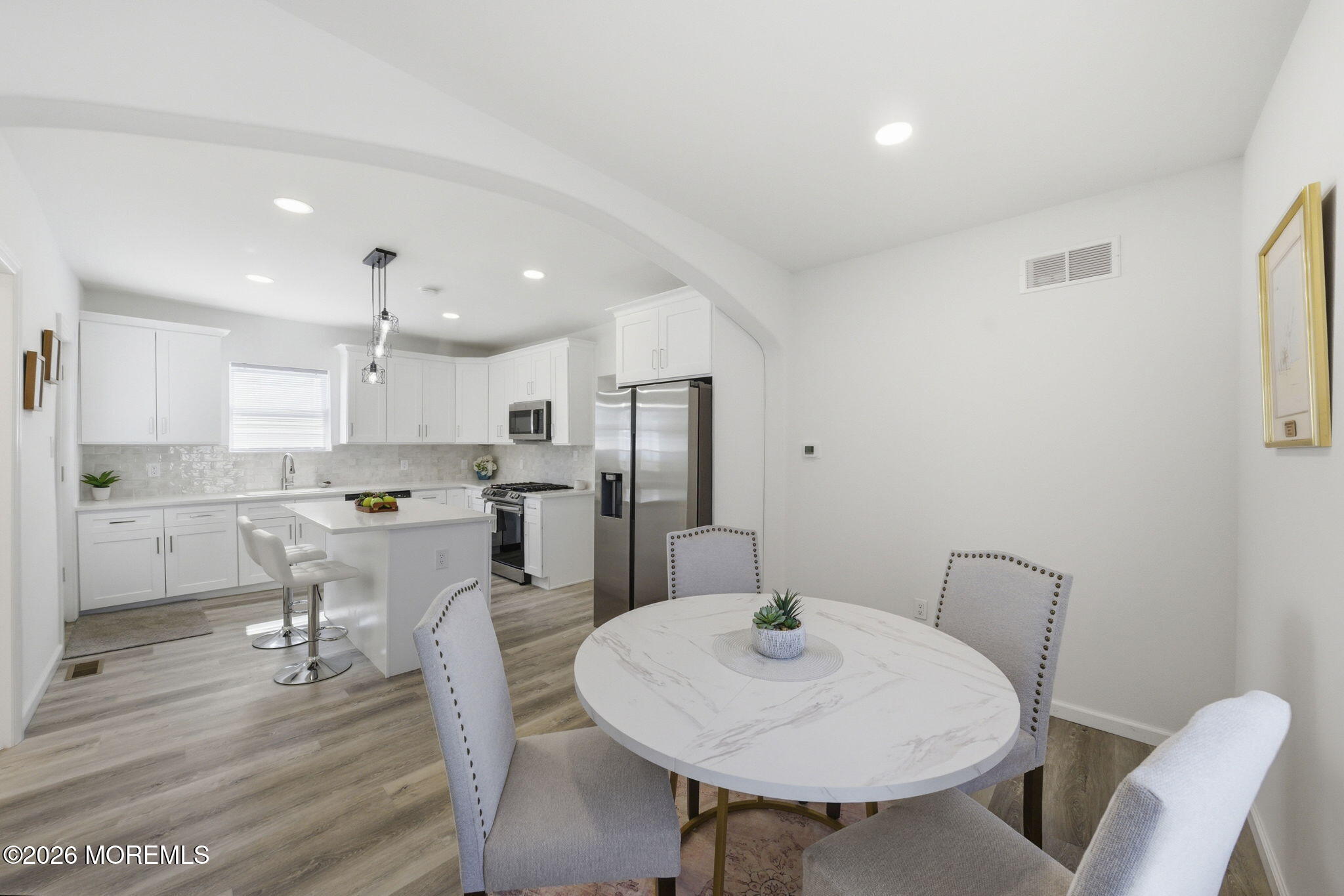 23 Beers Street Keyport, NJ 07735 - Photo 14 of 51 a kitchen with a dining table chairs and refrigerator