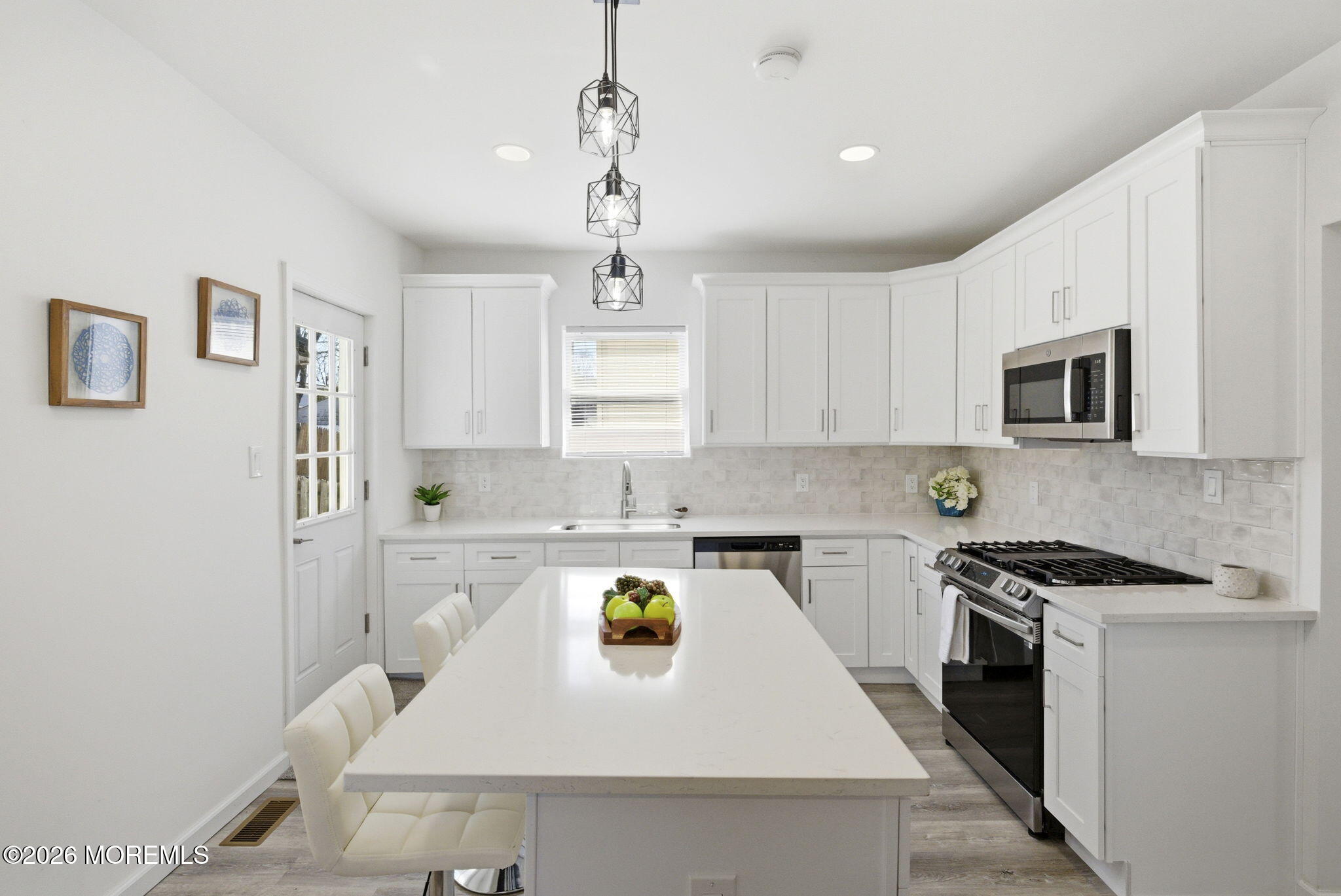 23 Beers Street Keyport, NJ 07735 - Photo 15 of 51 a kitchen with a stove a sink a microwave and cabinets