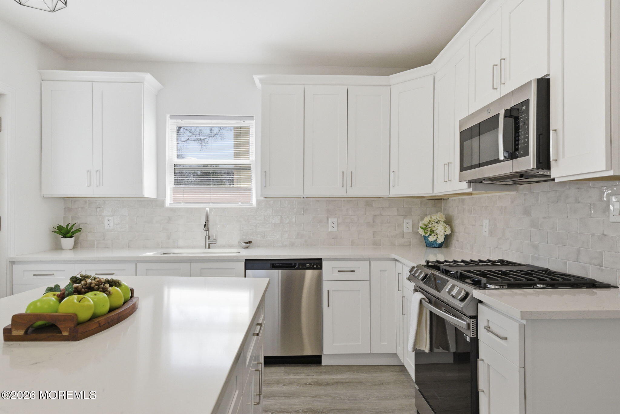 23 Beers Street Keyport, NJ 07735 - Photo 8 of 51 a kitchen with white cabinets and appliances