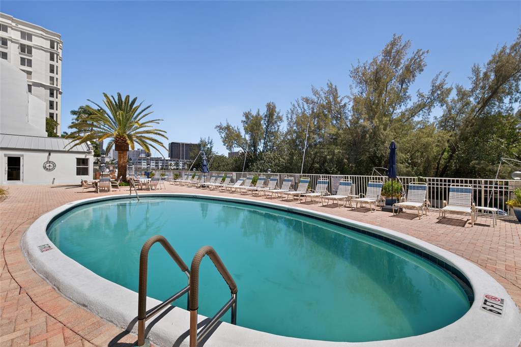 2850 Northeast 14th Street, Unit 410B Pompano Beach, FL 33062 - Photo 13 of 25 a view of a swimming pool with a patio