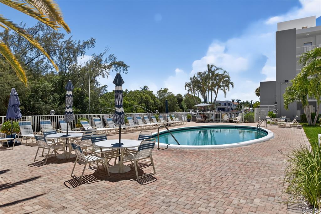 2850 Northeast 14th Street, Unit 410B Pompano Beach, FL 33062 - Photo 17 of 25 a table and chairs in the patio