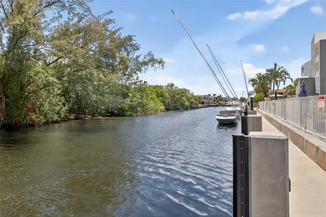 a patio with table and chairs and a barbeque