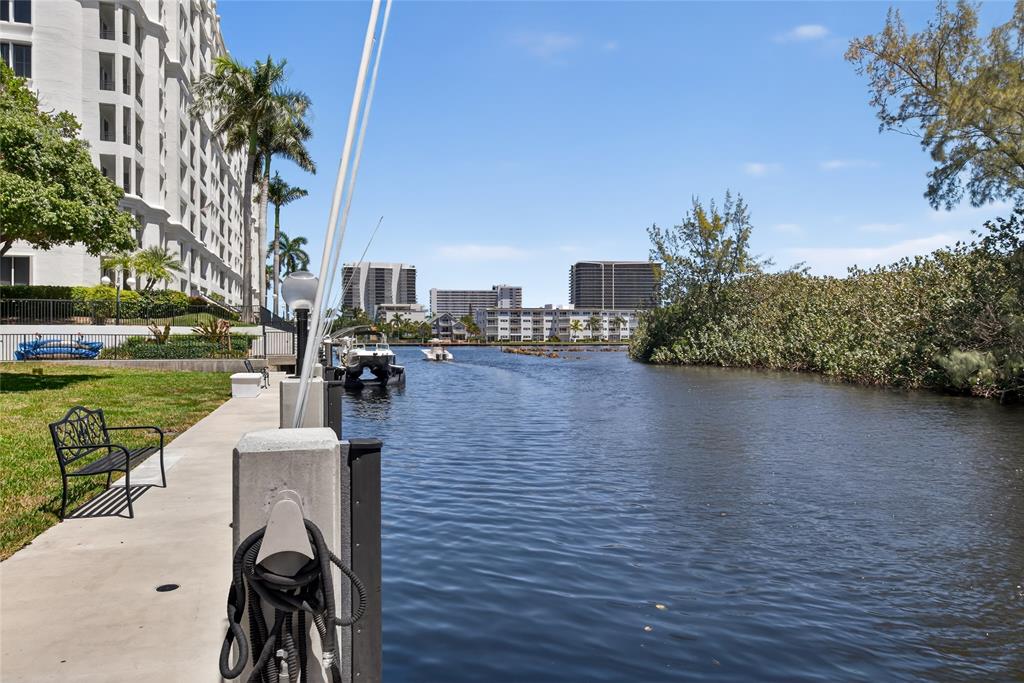 2850 Northeast 14th Street, Unit 410B Pompano Beach, FL 33062 - Photo 19 of 25 a patio with table and chairs and a barbeque