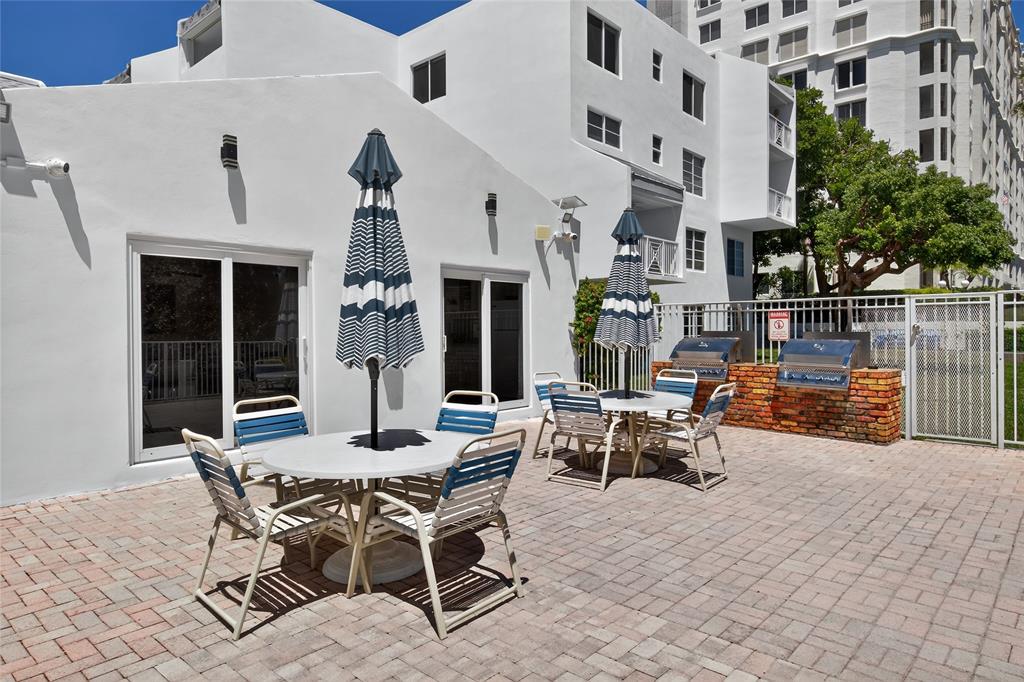 2850 Northeast 14th Street, Unit 410B Pompano Beach, FL 33062 - Photo 22 of 25 a view of a patio with couches table and chairs and potted plants