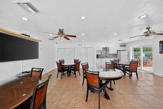 a living room with furniture kitchen view and a flat screen tv