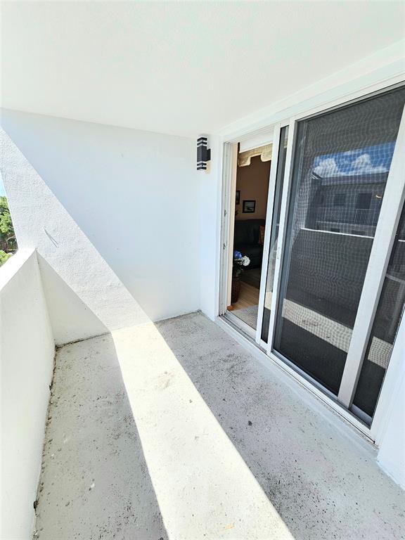 2850 Northeast 14th Street, Unit 410B Pompano Beach, FL 33062 - Photo 4 of 25 a view of a hallway with wooden floor and entryway