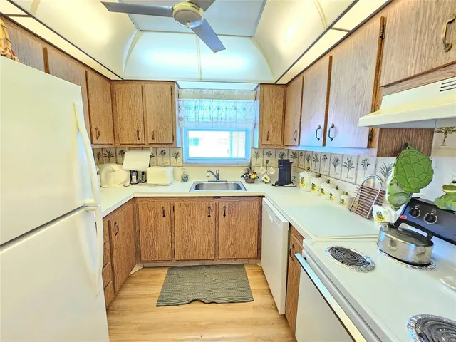 a kitchen with a sink a stove and cabinets