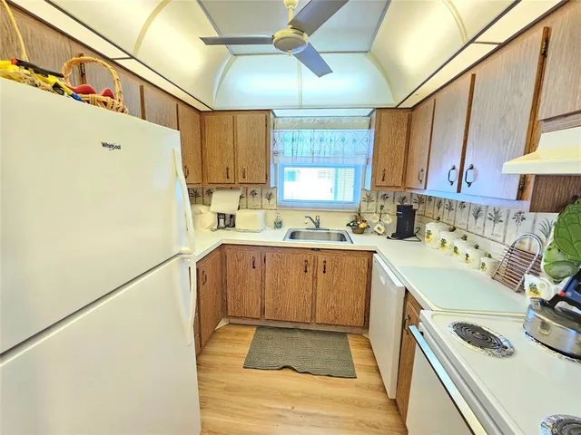 a kitchen with a sink a stove and cabinets