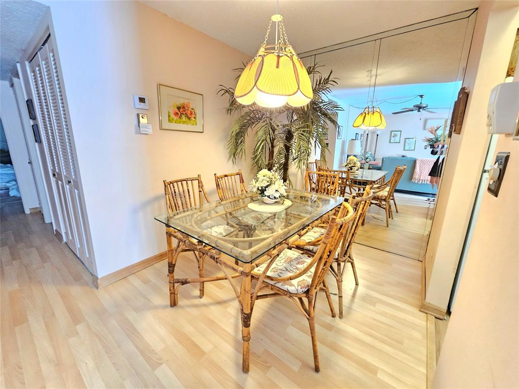 2850 Northeast 14th Street, Unit 410B Pompano Beach, FL 33062 - Photo 7 of 25 a dining room with furniture and a chandelier