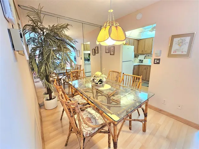 a view of a dining room with furniture and a chandelier