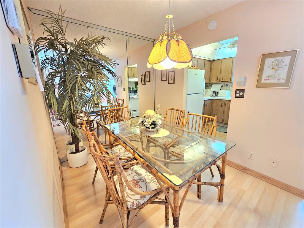 2850 Northeast 14th Street, Unit 410B Pompano Beach, FL 33062 - Photo 8 of 25 a view of a dining room with furniture and a chandelier