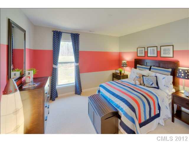 1444 Ridgehaven Road, Unit 146 Waxhaw, NC 28173 - Photo 12 of 16 a bedroom with a bed and glass windows
