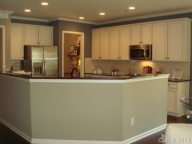 1444 Ridgehaven Road, Unit 146 Waxhaw, NC 28173 - Photo 4 of 16 a kitchen with stainless steel appliances a refrigerator sink and microwave