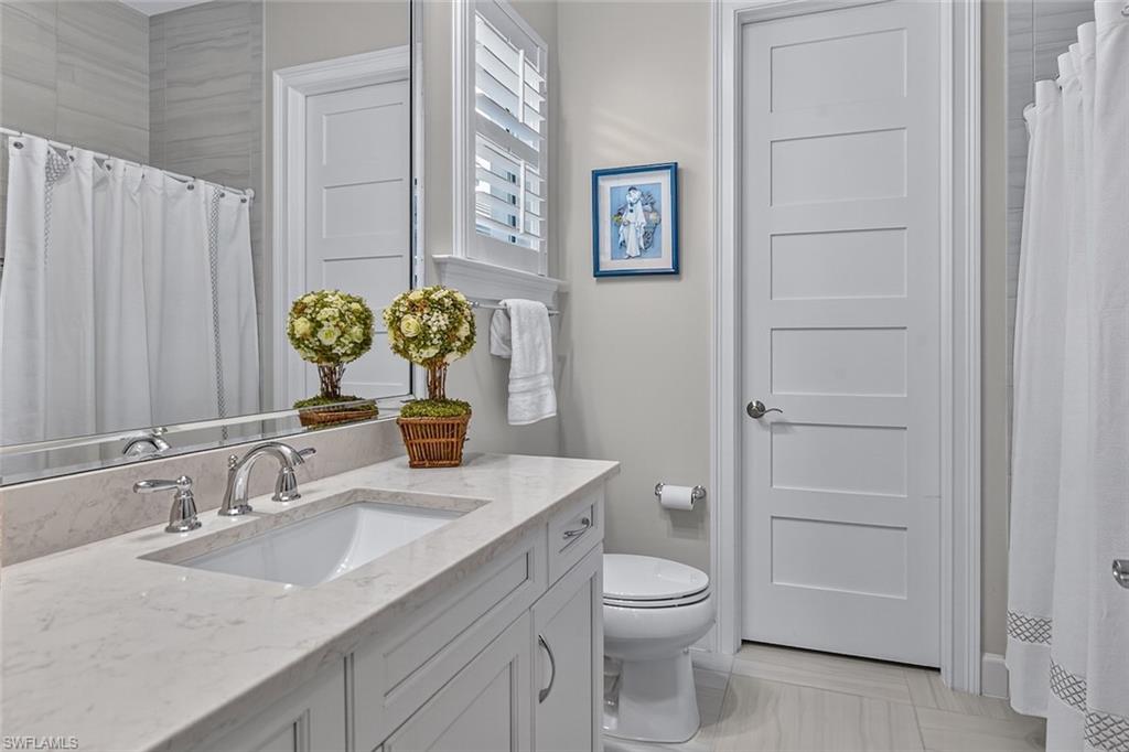 6387 Warwick Avenue Naples, FL 34113 - Photo 24 of 40 Full bathroom - ensuite to main residence guest bedroom, also featuring a walk in closet behind the door