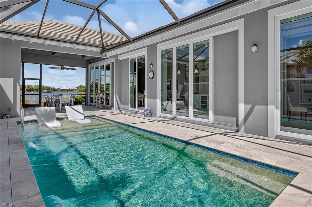 6387 Warwick Avenue Naples, FL 34113 - Photo 34 of 40 Heated swimming pool, showcasing wall of sliding glass doors that all fully pocket to maximize the inside/outside living