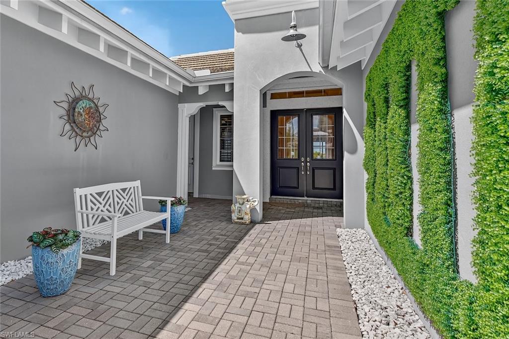 6387 Warwick Avenue Naples, FL 34113 - Photo 7 of 40 Front entry courtyard and entrance to the main residence