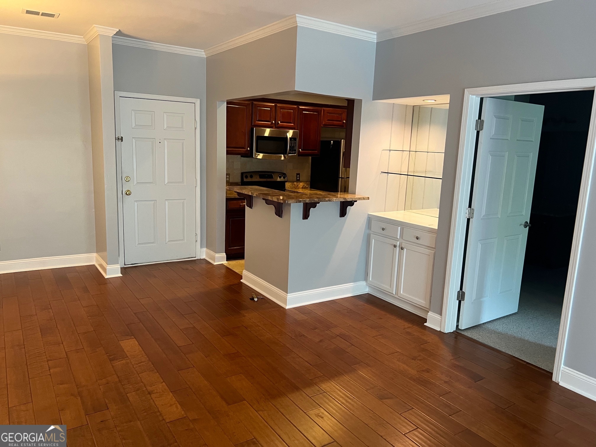3071 Lenox Road Northeast, Unit 39 Atlanta, GA 30324 - Photo 13 of 29 a view of a kitchen with wooden floor and cabinets