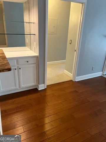 a view of room with window and wooden floor