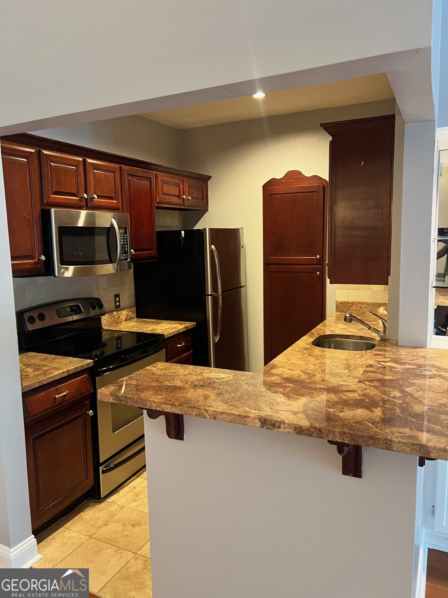 3071 Lenox Road Northeast, Unit 39 Atlanta, GA 30324 - Photo 19 of 29 a kitchen with stainless steel appliances granite countertop a refrigerator and a stove top oven
