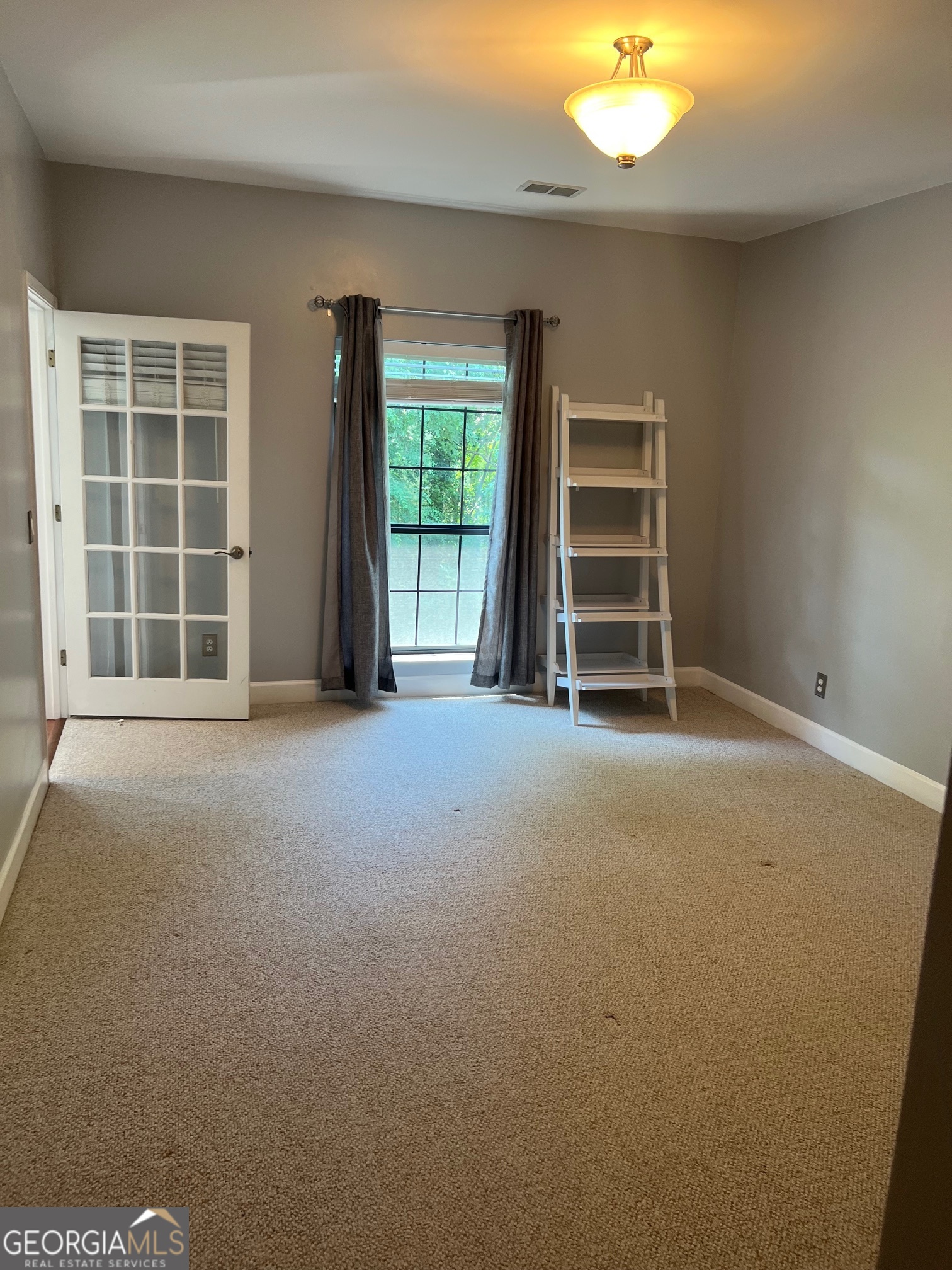 3071 Lenox Road Northeast, Unit 39 Atlanta, GA 30324 - Photo 21 of 29 a view of an empty room with a window
