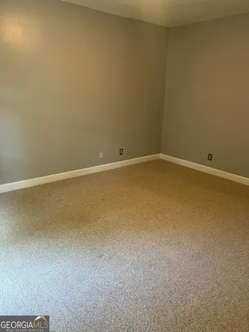 a view of empty room with a flat screen tv